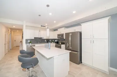 a kitchen with white cabinets and stainless steel appliances at 3120-206DR STOREY LAKE, CONDO 2/2 GARDEN VIEW in Kissimmee