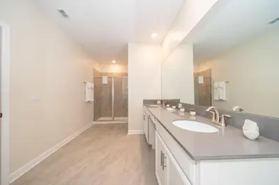 a bathroom with a sink and a large mirror at 2731EE VILLA 5 BED/5 BA (SANITIZED) in Kissimmee