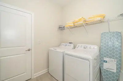 a laundry room with a washer and dryer at 2731EE VILLA 5 BED/5 BA (SANITIZED) in Kissimmee