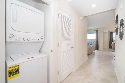 a white laundry room with a washer and dryer at 3111-302HM STOREY LAKE, CONDO 2/2 LAKE VIEW in Kissimmee