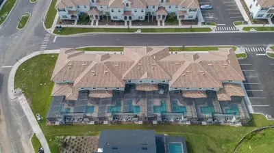 an aerial view of a house with a roof at 4964RS TOWNHOUSE 4 BEDROOMS & 3 BATHROOMS + POOL in Kissimmee