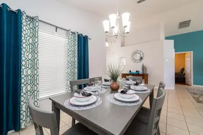 a dining room with a table and chairs at 16150EGRET- Sun Chaser (S) in Orlando