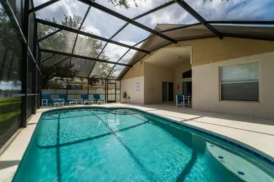 an indoor swimming pool with a glass ceiling at 16150EGRET- Sun Chaser (S) in Orlando