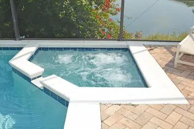 a swimming pool with a bench around it at 2685OL - Jagu Deaux (G) in Kissimmee