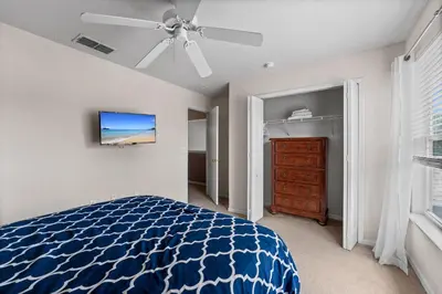 a bedroom with a blue bed and a ceiling fan at 1323ZUREIQ-Zureiq Dreams (S) in Orlando