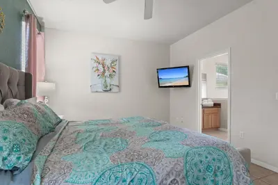a bedroom with a bed and a flat screen tv at 1323ZUREIQ-Zureiq Dreams (S) in Orlando