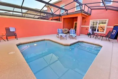 a swimming pool in a patio with chairs and tables at 8975CPR - Waites Home (G) in Kissimmee