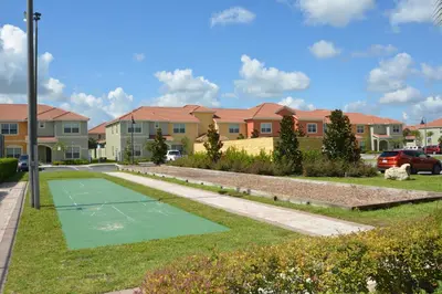 a tennis court in front of some houses at 8975CPR - Waites Home (G) in Kissimmee