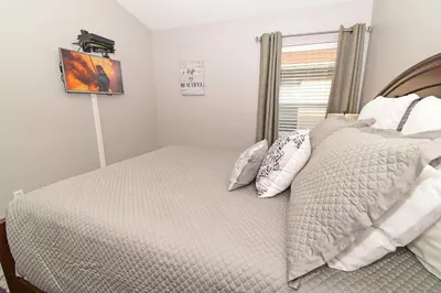 a bedroom with a bed with pillows and a window at 4639EPD - Comfort Island (G) in Kissimmee