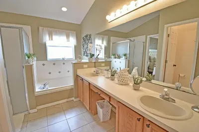 a bathroom with two sinks and a large mirror at 4639EPD - Comfort Island (G) in Kissimmee