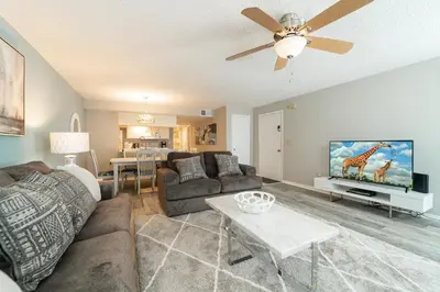 a living room with a couch and a tv at VOS-2739PB-73 - Somerset Gardens (S) in Kissimmee