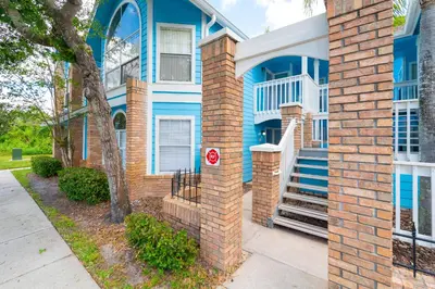 a blue house with stairs in front of it at VOS-2739PB-73 - Somerset Gardens (S) in Kissimmee