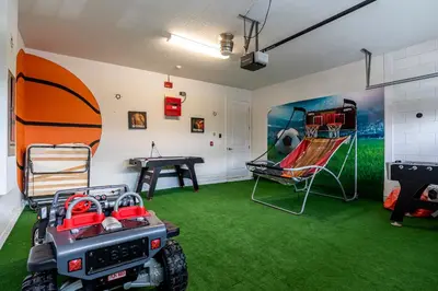 a room with green carpet and a room with a golf cart at Upscale Modern Getaway home with heated pool/hot tub, 9 beds 8.5 bath Sleeps 18+ in Orlando