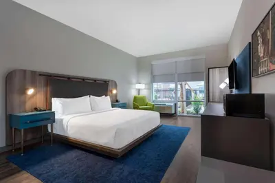 a hotel room with a bed and a television at TRYP by Wyndham Orlando in Orlando