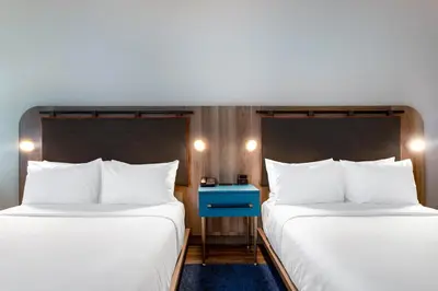 two beds sitting next to each other in a room at TRYP by Wyndham Orlando in Orlando