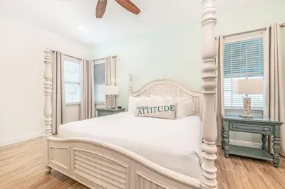 a white bedroom with a white bed and two tables at Sanderella Castle! Premium Cottage With Private Hot Tub Near Disney With Margaritaville Resort & Island H2O Access - 3037Sp in Orlando