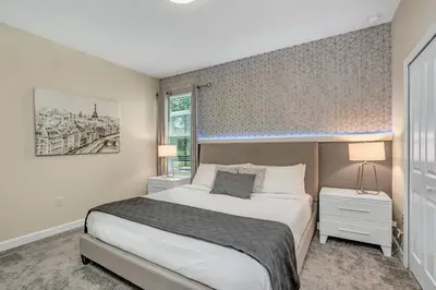 a bedroom with a large bed and a window at Storey Lake Resort 5 Bedroom Vacation Home with Pool 2307 in Kissimmee