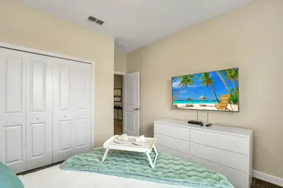 a bedroom with a white door and a white dresser at Storey Lake Resort 5 Bedroom Vacation Home with Pool 2307 in Kissimmee