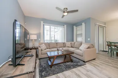 a living room with a couch and a table at 4907JA TOWNHOUSE 4 BEDROOMS & 3 BATHROOMS + POOL in Kissimmee