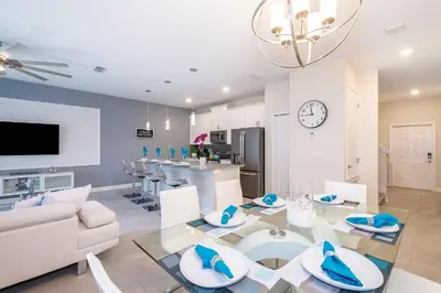 a living room with a table and a dining room at 4819JA TOWNHOUSE 4 BEDROOMS & 3 BATHROOMS + POOL in Kissimmee