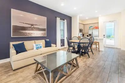 a living room with a couch and a table at Celestial Cottage Near Disney With Margaritaville Resort & Island H2O Access - 8036Dr in Orlando
