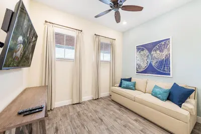 a living room with a couch and a ceiling fan at Celestial Cottage Near Disney With Margaritaville Resort & Island H2O Access - 8036Dr in Orlando