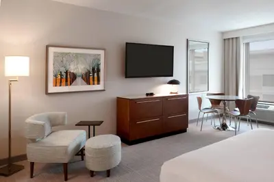 a hotel room with a bed and a tv and a table at TownePlace Suites by Marriott Orlando Downtown in Orlando