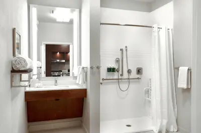 a bathroom with a shower and a sink at TownePlace Suites by Marriott Orlando Downtown in Orlando