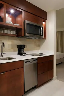 a kitchen with a sink and a microwave at TownePlace Suites by Marriott Orlando Downtown in Orlando