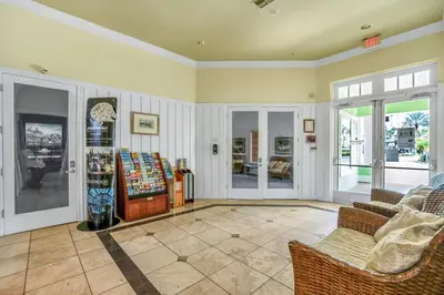 a room with a store with a cash register and chairs at 2 Bedroom Vacation Condo 2011 in Kissimmee