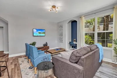 a living room with a couch and blue chairs at 2 Bedroom Vacation Condo 2011 in Kissimmee