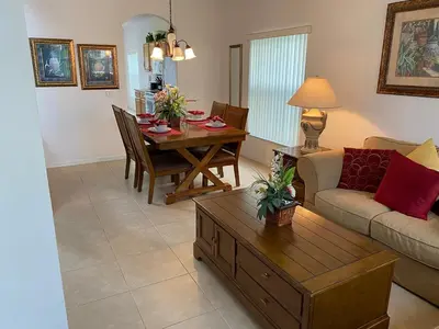 a living room with a couch and a dining room table at Platinum Vacation Homes of Orlando in Orlando