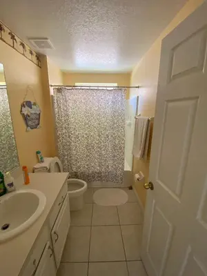 a bathroom with a sink and a toilet and a shower at Platinum Vacation Homes of Orlando in Orlando