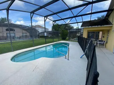a swimming pool with a glass canopy over it at Platinum Vacation Homes of Orlando in Orlando