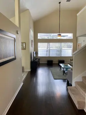 an empty living room with a couch and a table at Platinum Vacation Homes of Orlando in Orlando
