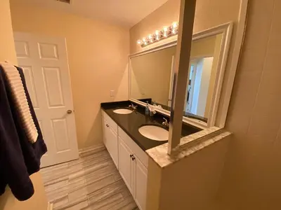 a bathroom with two sinks and a large mirror at Platinum Vacation Homes of Orlando in Orlando