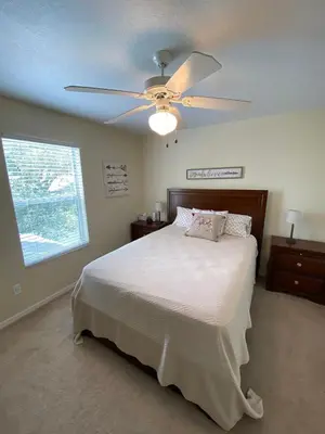 a bedroom with a bed with a ceiling fan at Platinum Vacation Homes of Orlando in Orlando