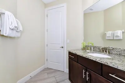 a bathroom with a sink and a mirror at Amazing Home With Theme Rooms, Game Rooms Near Disney With Waterpark & Resort Access At Encore Resort - 7647Wl in Kissimmee