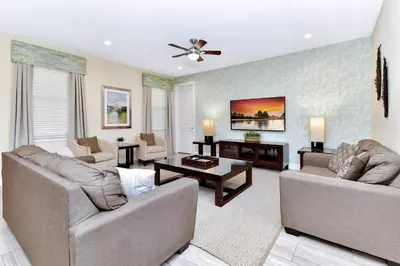 a living room with two couches and a table at Amazing Home With Theme Rooms, Game Rooms Near Disney With Waterpark & Resort Access At Encore Resort - 7647Wl in Kissimmee