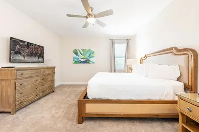 a bedroom with a bed and a ceiling fan at Vibrant Home With Private Pool, Pool Table Near Disney With Waterpark & Resort Access At Encore Resort - 7707Gr in Kissimmee