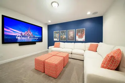 a living room with a white couch and a tv at Vibrant Home With Private Pool, Pool Table Near Disney With Waterpark & Resort Access At Encore Resort - 7707Gr in Kissimmee