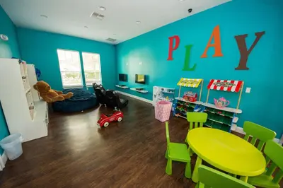 a play room with a green table and green chairs at HAPPY PORT, your home very close to entertainment in Kissimmee