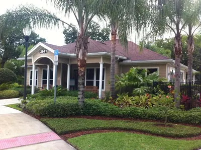 a house with palm trees in front of it at HAPPY PORT, your home very close to entertainment in Kissimmee