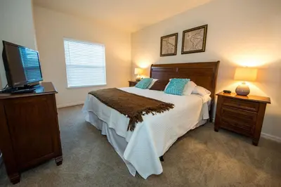 a bedroom with a bed and a flat screen tv at HAPPY PORT, your home very close to entertainment in Kissimmee