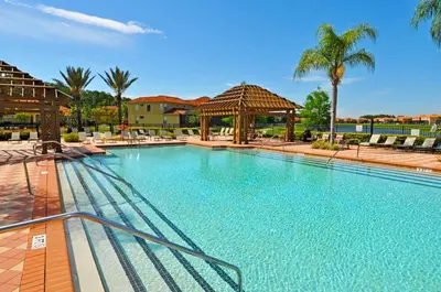 a large swimming pool with a gazebo and palm trees at Fantastic 4br 3ba with Pvt Pool near to Disney in Kissimmee