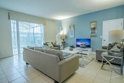 a living room with a couch and a tv at Fantastic 4br 3ba with Pvt Pool near to Disney in Kissimmee