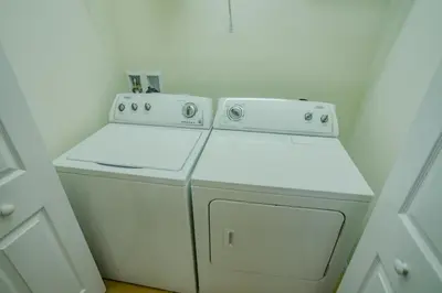 a white washer and dryer in a room at Fantastic 4br 3ba with Pvt Pool near to Disney in Kissimmee