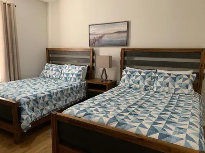 a bedroom with two beds and a picture on the wall at 205 - Disney, Universal, Convention Center in Orlando