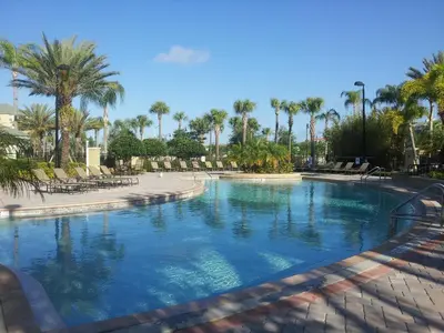 a swimming pool in a resort with palm trees at 205 - Disney, Universal, Convention Center in Orlando