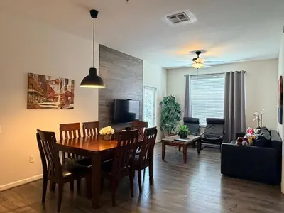 a dining room and living room with a table and chairs at 210 Disney Universal Convention Center in Orlando